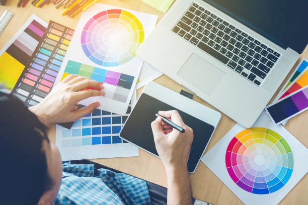 Graphic designer drawing on graphics tablet at workplace Amen Graphics Amen Graphics